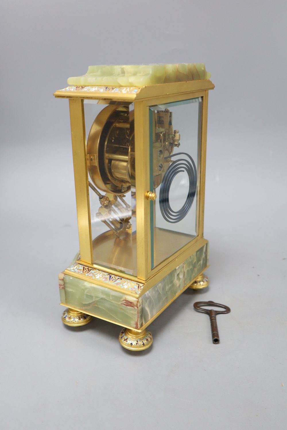 An early 20th century French green onyx, champleve enamel and ormolu mantel clock, includes key, height 27cm